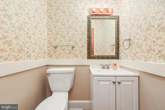 a view of empty room with wooden floor and stairs