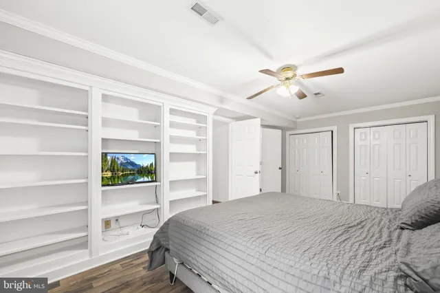 a bedroom with a bed dresser and a window