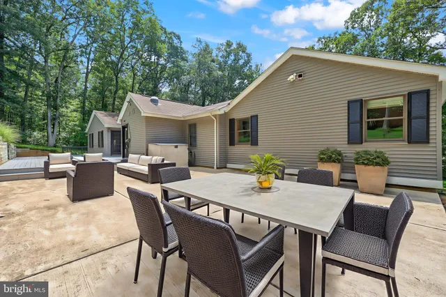 a backyard of a house with yard and outdoor seating