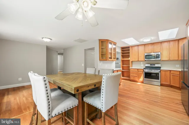 a kitchen with stainless steel appliances granite countertop a refrigerator stove microwave and sink