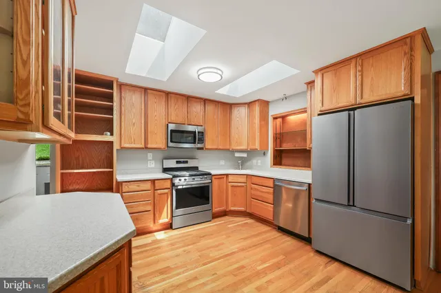 a kitchen with stainless steel appliances granite countertop a sink and cabinets