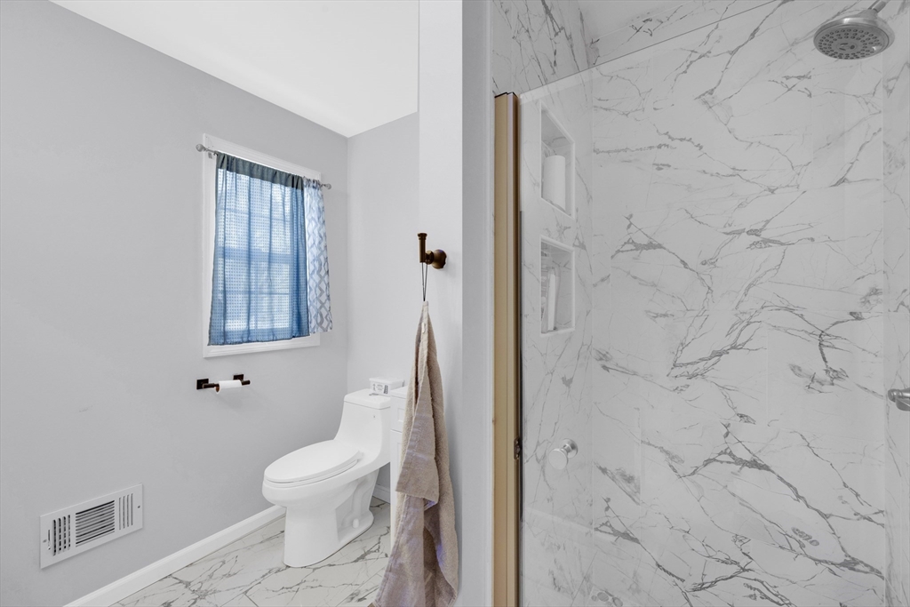42 Ringgold Street Springfield, MA 01107 - Photo 22 of 38 a white toilet sitting next to a bathroom sink