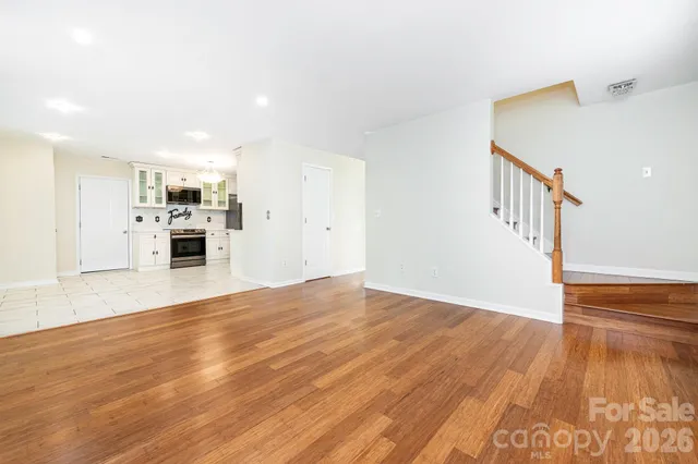 a view of a kitchen with wooden floor and a kitchen