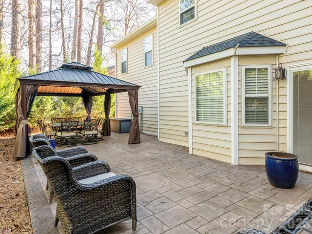 a view of a patio with a table and chairs next to a yard