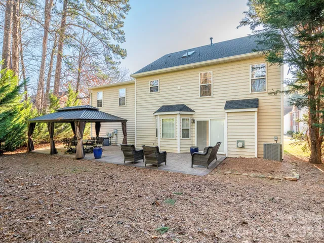 a view of a house with backyard porch and sitting area