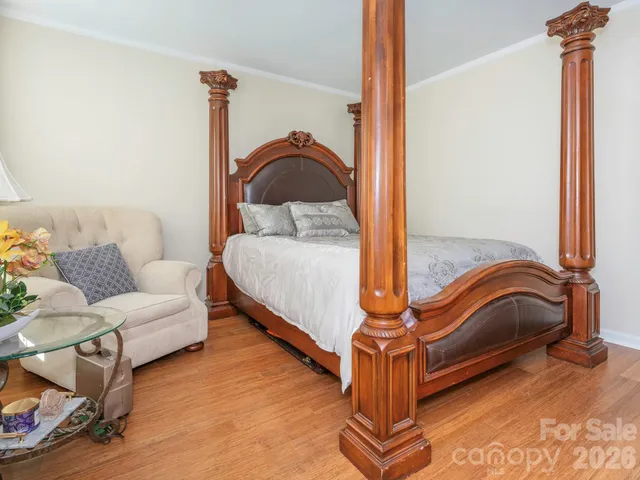 a bedroom with furniture and a mirror