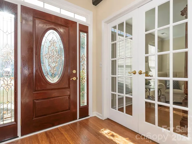 a view of a livingroom with wooden floor and a large window
