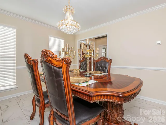a dining room with furniture and chandelier