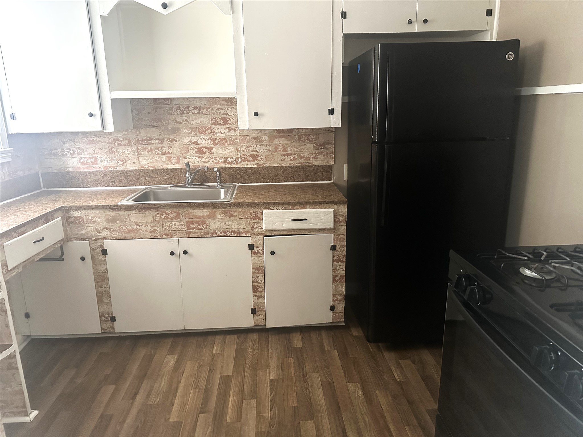 11005 Muscatine Street Houston, TX 77029 - Photo 6 of 12 a kitchen with granite countertop a refrigerator and a stove