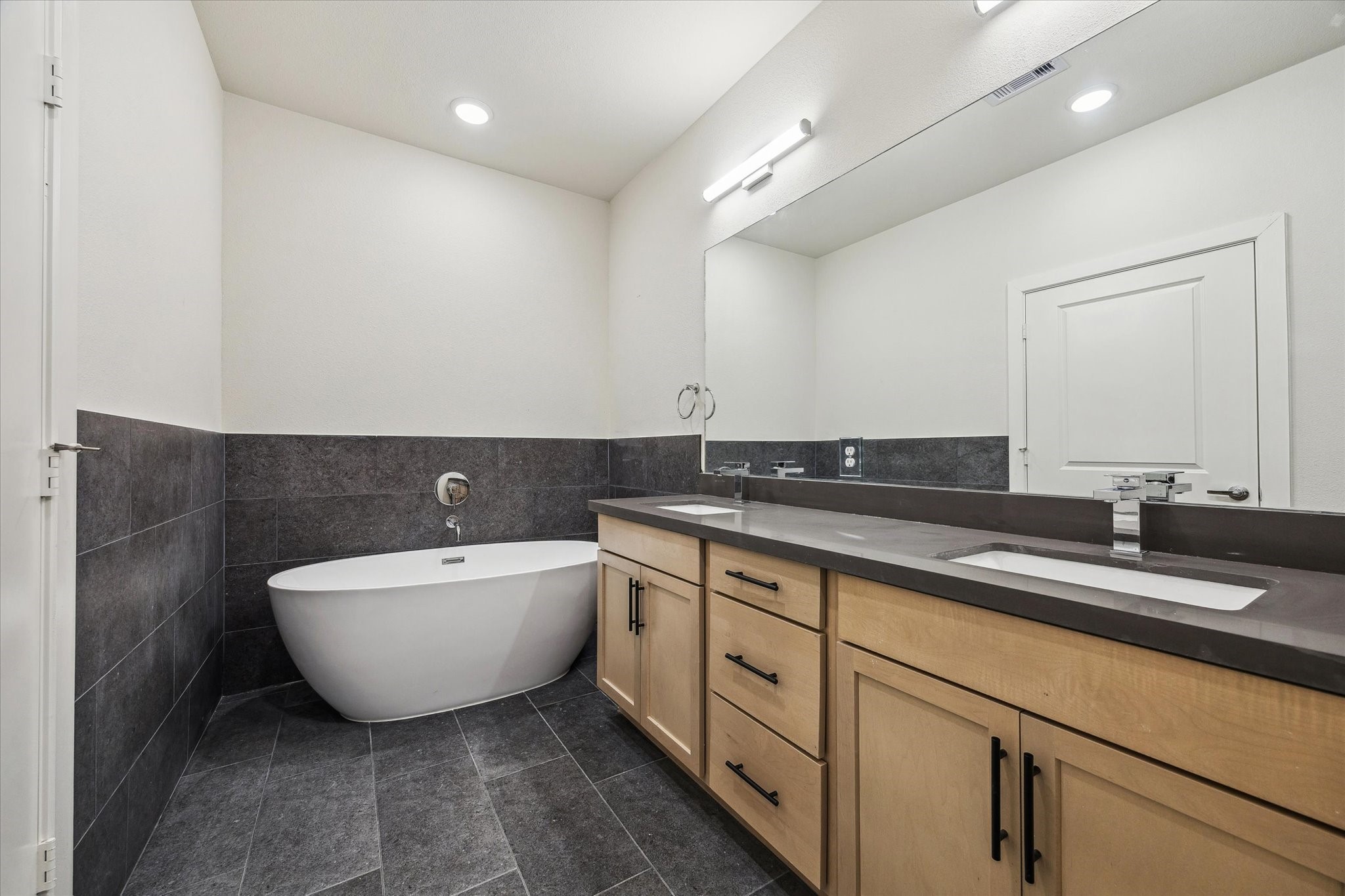 6517 Rena Street Houston, TX 77092 - Photo 8 of 11 a spacious bathroom with a double vanity sink mirror and bathtub