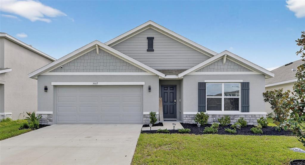 3602 Forest Path Drive Plant City, FL 33565 - Photo 1 of 75 a front view of a house with a yard and garage