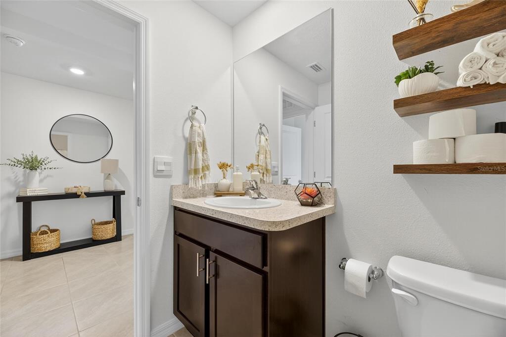 3602 Forest Path Drive Plant City, FL 33565 - Photo 15 of 75 a bathroom with a toilet sink and mirror