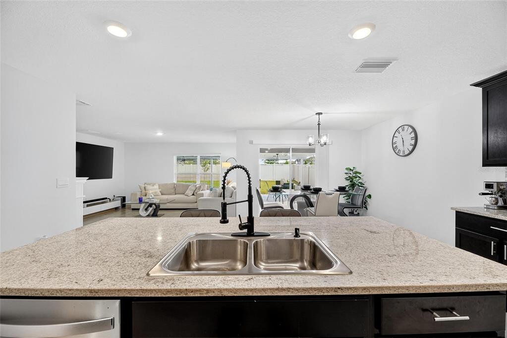 3602 Forest Path Drive Plant City, FL 33565 - Photo 27 of 75 a kitchen with kitchen island granite countertop a sink and a stove