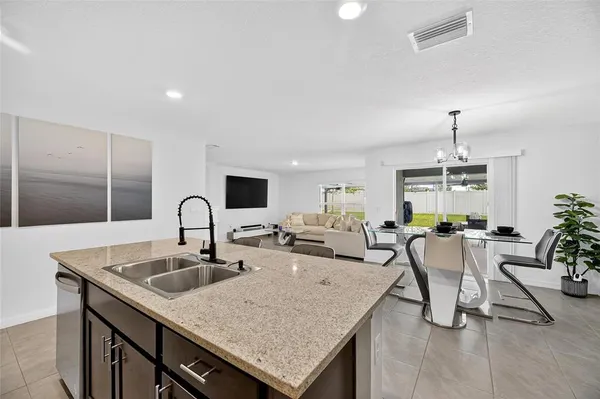 a bathroom with a granite countertop sink a shower and mirror
