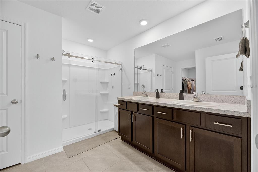 3602 Forest Path Drive Plant City, FL 33565 - Photo 38 of 75 a bathroom with a double vanity sink mirror double and shower