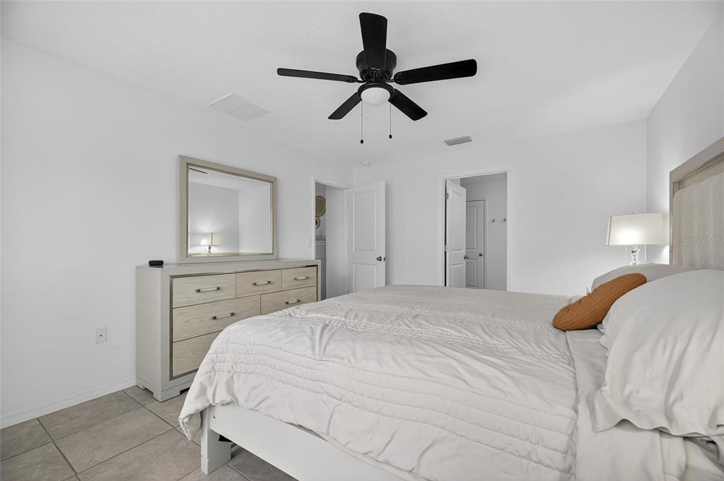 3602 Forest Path Drive Plant City, FL 33565 - Photo 42 of 75 a bedroom with a bed and a chandelier