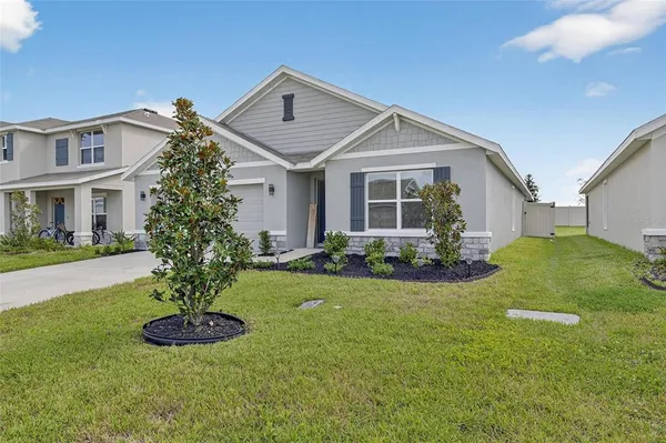 a front view of a house with a yard and garage