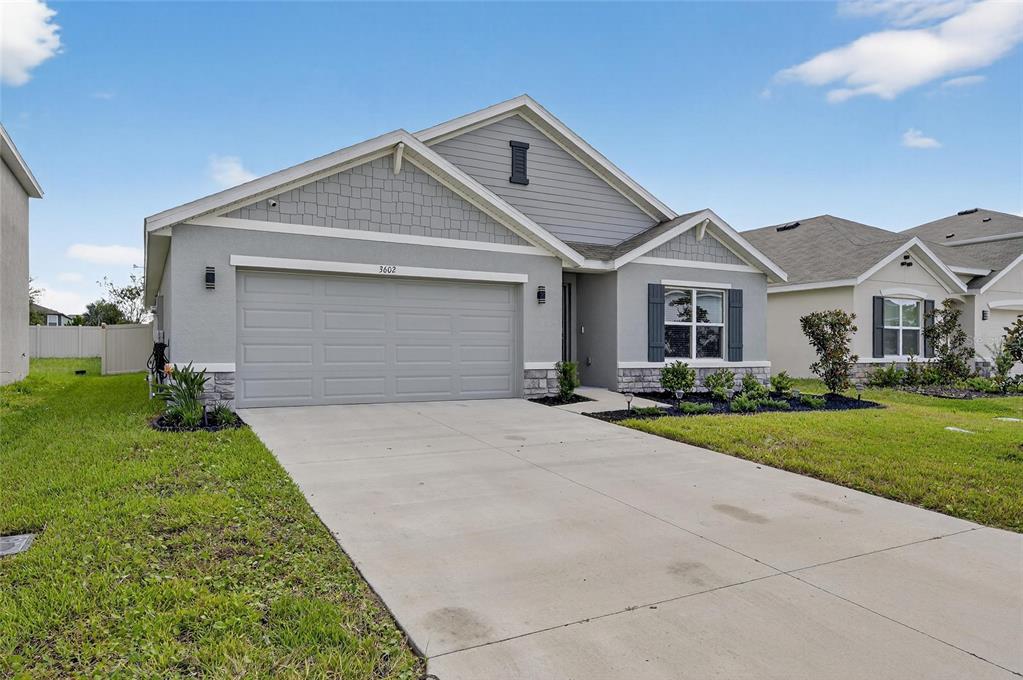 3602 Forest Path Drive Plant City, FL 33565 - Photo 7 of 75 a front view of a house with a yard and garage