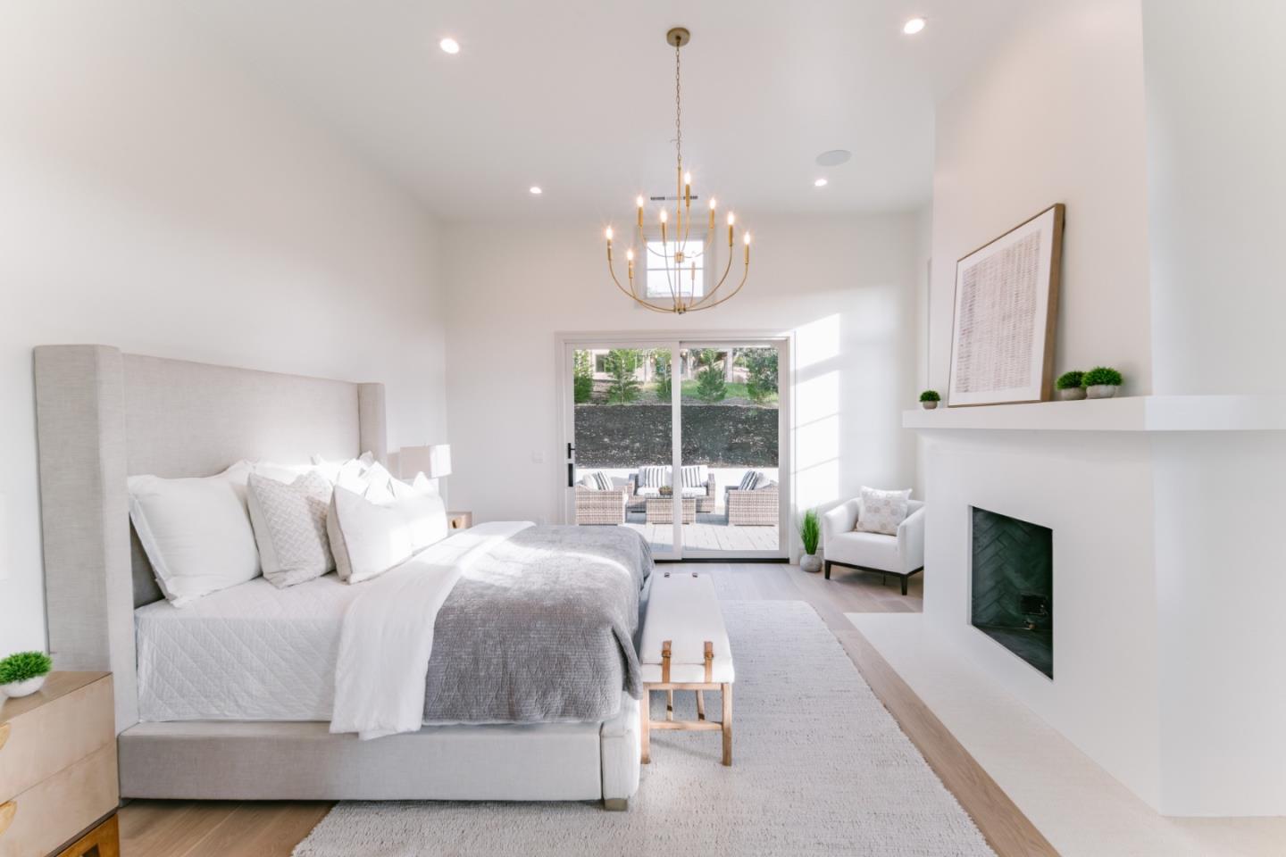 8210 Manjares Road Monterey, CA 93940 - Photo 40 of 76 a spacious bedroom with a bed and a fireplace