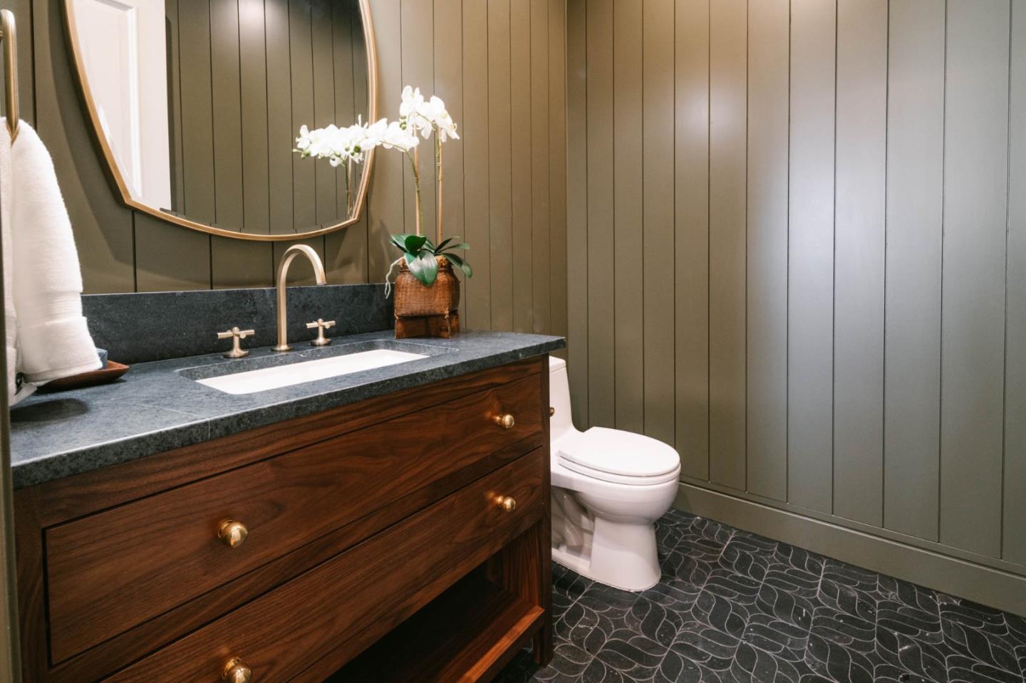 8210 Manjares Road Monterey, CA 93940 - Photo 53 of 76 a bathroom with a toilet a sink and mirror