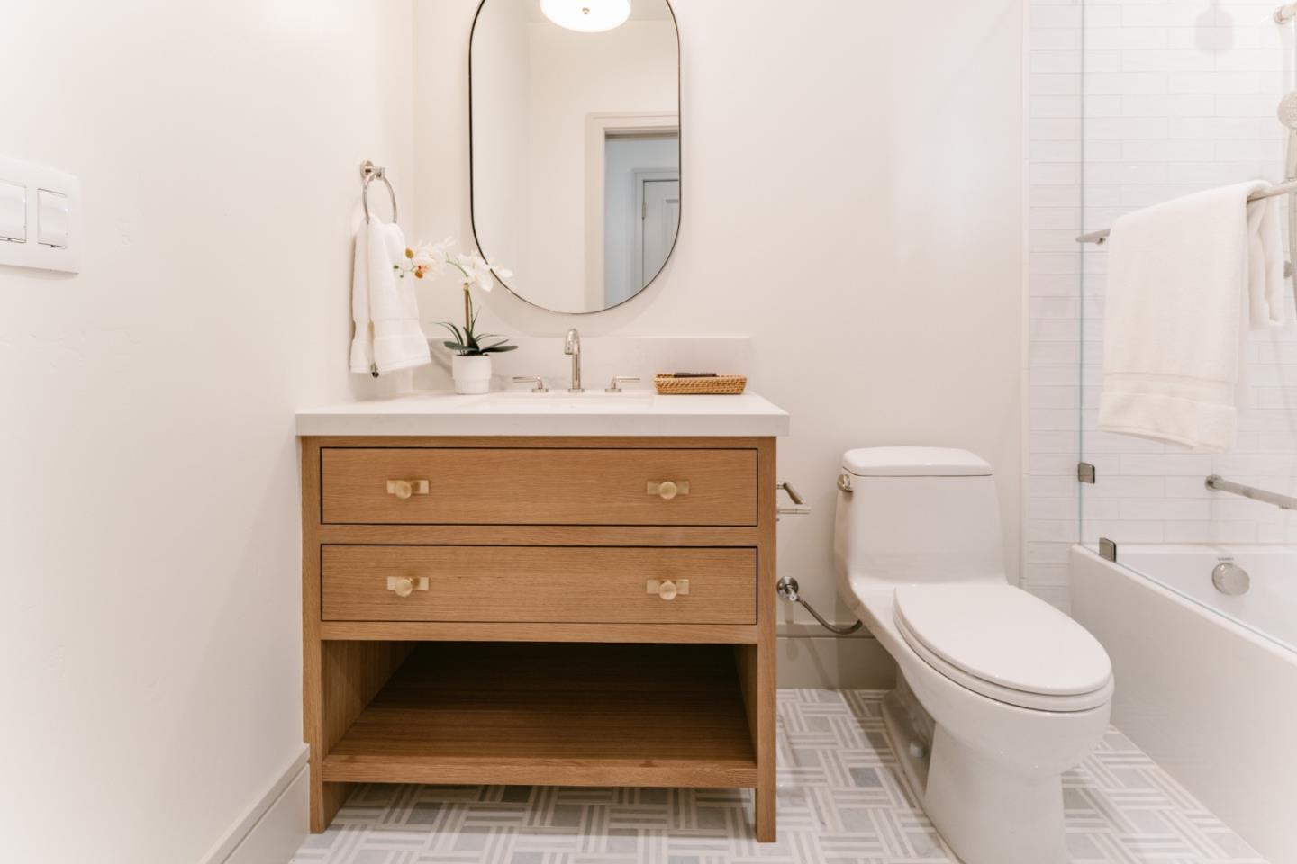 8210 Manjares Road Monterey, CA 93940 - Photo 62 of 76 a bathroom with a toilet a sink and mirror