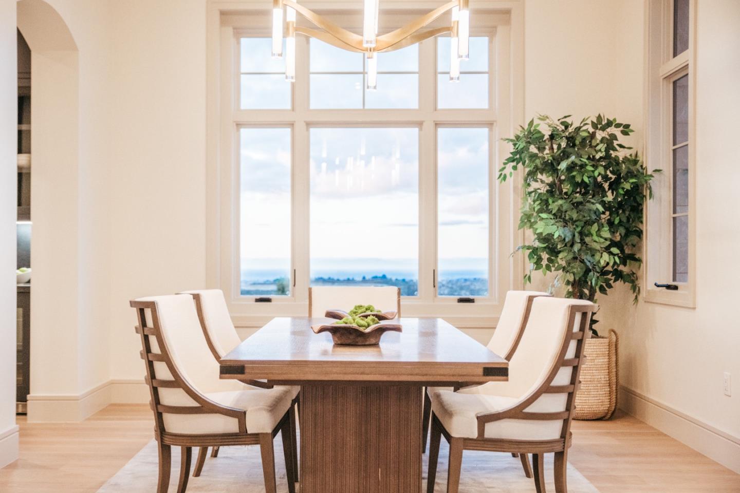 8210 Manjares Road Monterey, CA 93940 - Photo 10 of 76 a view of a dining room with furniture large windows and wooden floor