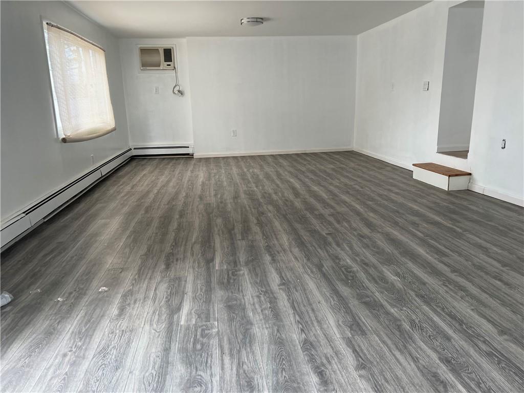212 Manor Road Staten Island, NY 10314 - Photo 6 of 12 a view of an empty room and wooden floor