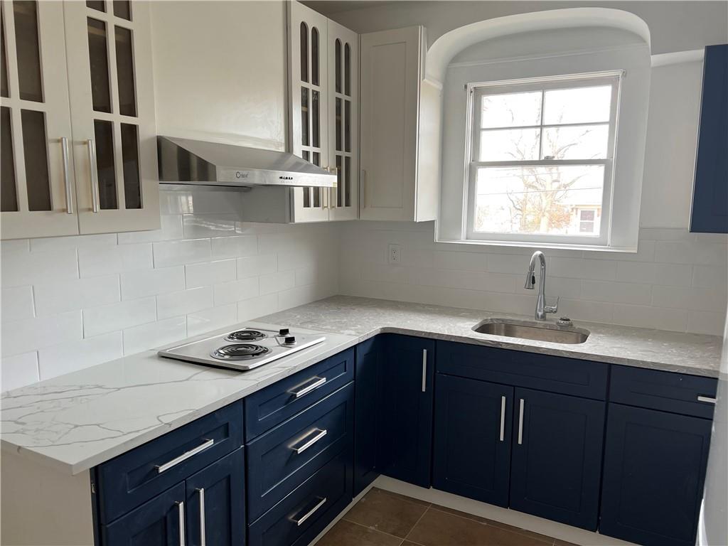 212 Manor Road Staten Island, NY 10314 - Photo 7 of 12 a kitchen with stainless steel appliances a sink dishwasher a stove and a refrigerator