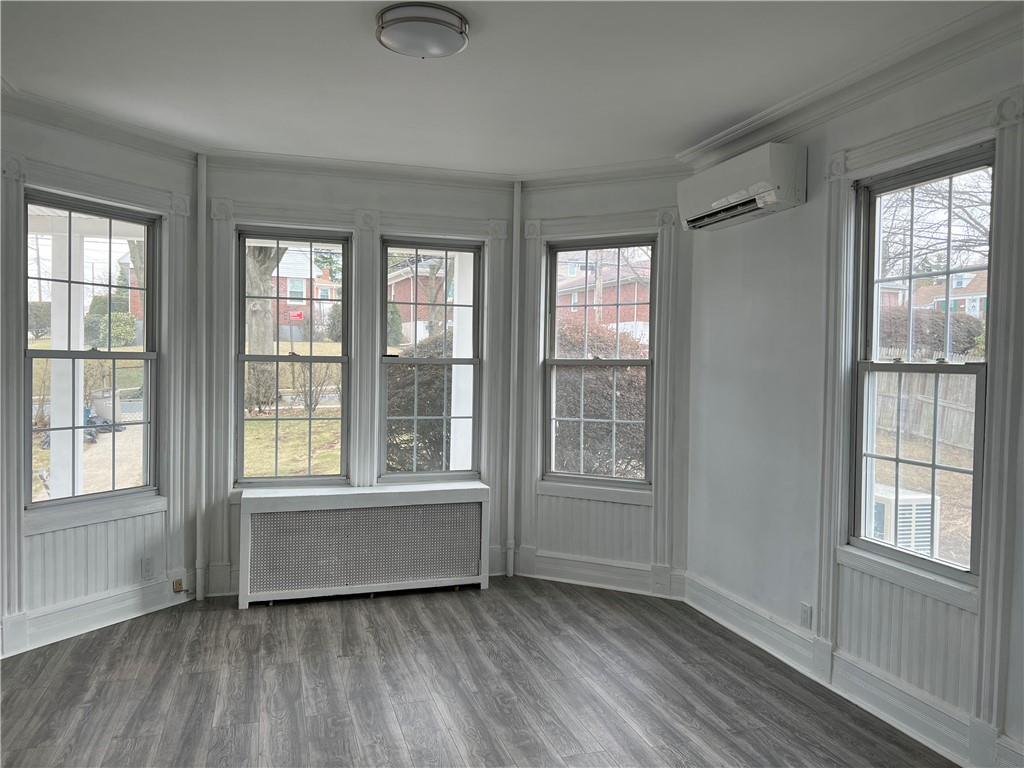 212 Manor Road Staten Island, NY 10314 - Photo 9 of 12 an empty room with wooden floor and windows