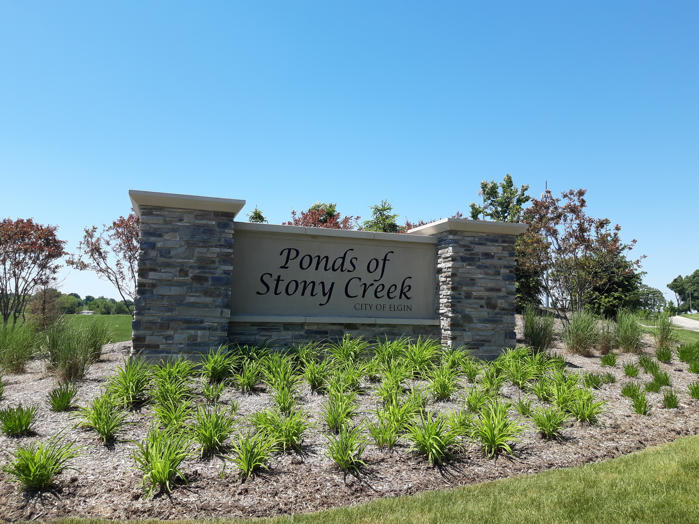 3628 Edelweiss Road Elgin, IL 60124 - Photo 22 of 38 a sign that is sitting in front of flowers