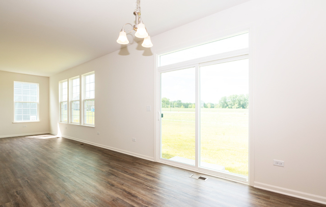 3628 Edelweiss Road Elgin, IL 60124 - Photo 7 of 38 a view of an empty room with wooden floor and a window