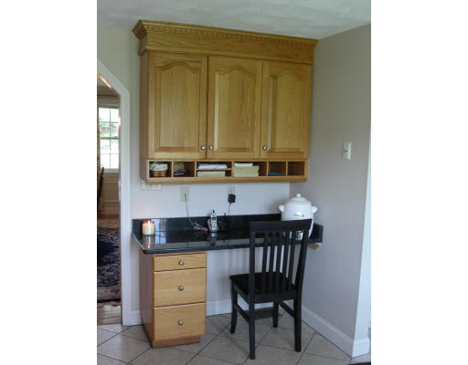 5 Baldwin Road Westford, MA 01886 - Photo 5 of 28 a kitchen with a chair and cabinets