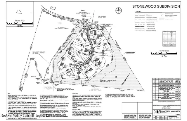 a view of a yard with plants and a large tree