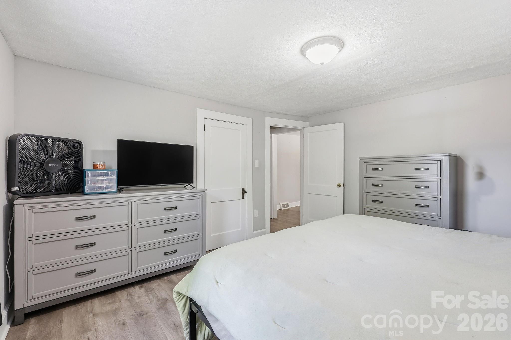 197 Mulberry Street Clyde, NC 28721 - Photo 14 of 31 a bedroom with a bed and a television