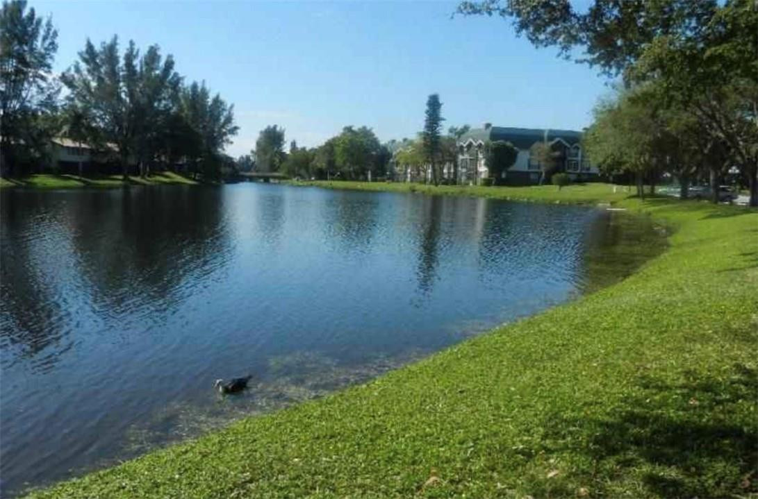 3670 Inverrary Drive, Unit 1E Lauderhill, FL 33319 - Photo 12 of 15 an aerial view of a house with a yard and lake view