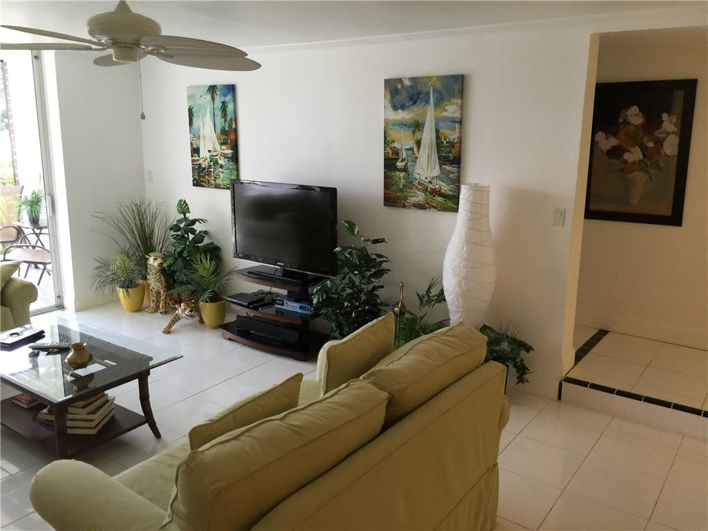 3670 Inverrary Drive, Unit 1E Lauderhill, FL 33319 - Photo 4 of 15 a living room with furniture and a flat screen tv