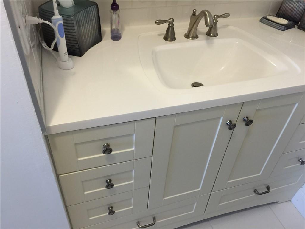 3670 Inverrary Drive, Unit 1E Lauderhill, FL 33319 - Photo 6 of 15 a bathroom with a sink and mirror