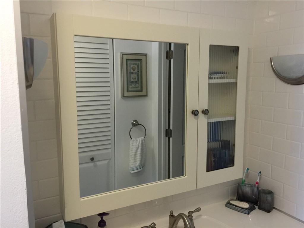 3670 Inverrary Drive, Unit 1E Lauderhill, FL 33319 - Photo 7 of 15 a bathroom with a sink and a mirror