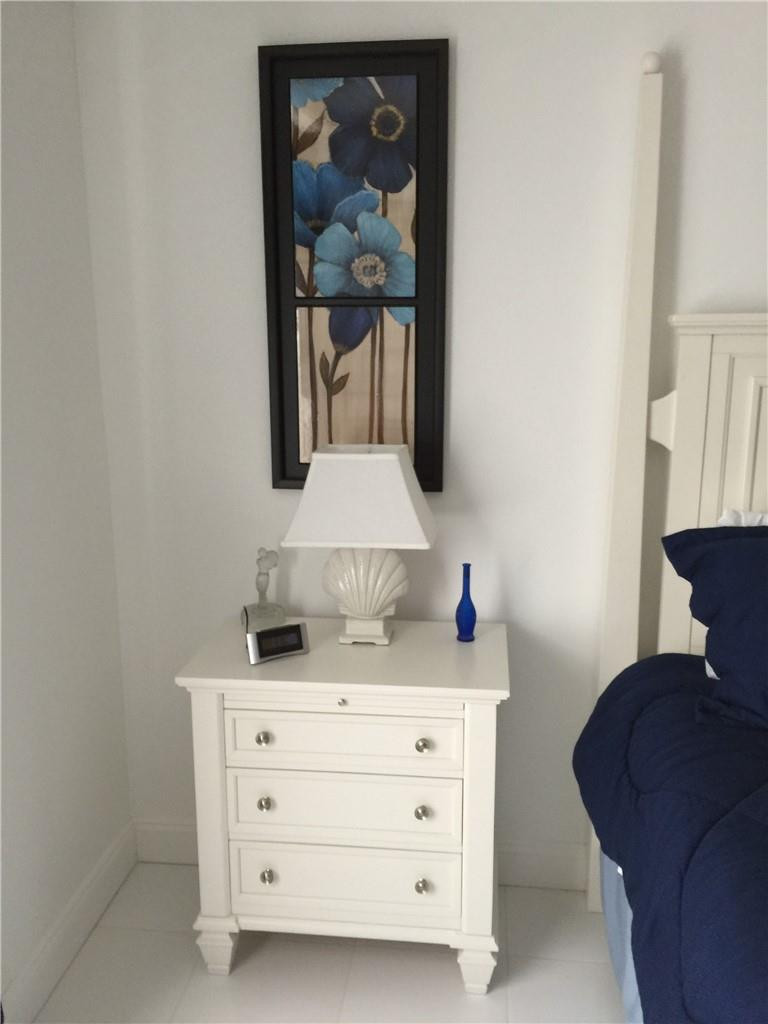 3670 Inverrary Drive, Unit 1E Lauderhill, FL 33319 - Photo 8 of 15 a bathroom with a sink a mirror and painting on the wall