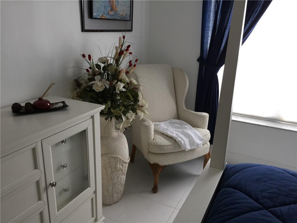 3670 Inverrary Drive, Unit 1E Lauderhill, FL 33319 - Photo 9 of 15 a living room with furniture and a potted plant