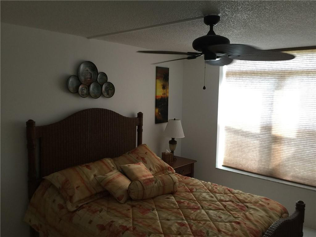 3670 Inverrary Drive, Unit 1E Lauderhill, FL 33319 - Photo 10 of 15 a bedroom with a bed and a window