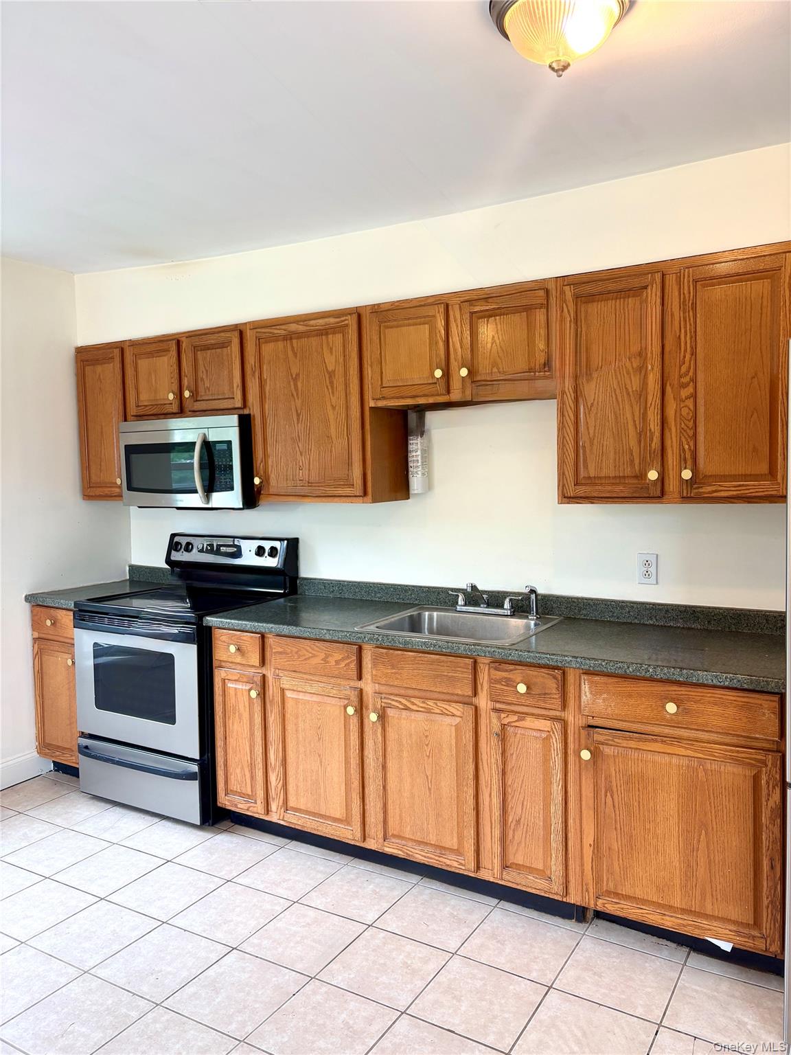 2 Morris Avenue, Unit 203 Cold Spring, NY 10516 - Photo 8 of 32 a kitchen with granite countertop a sink and cabinets