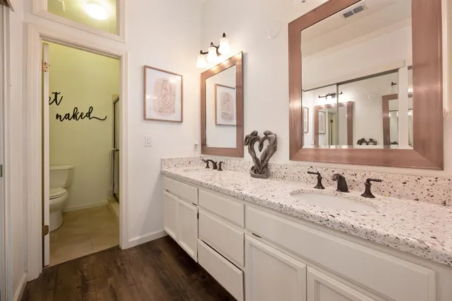 a bathroom with a granite countertop sink and a mirror
