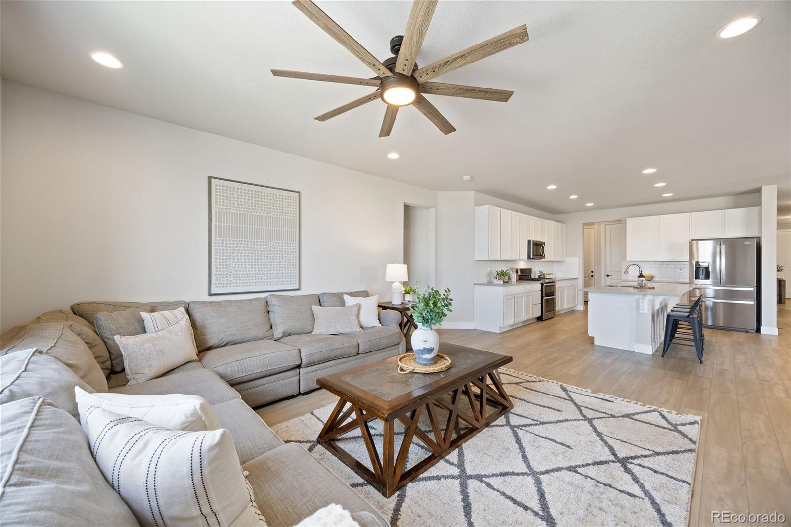 12649 Buffington Trail Parker, CO 80134 - Photo 14 of 47 a living room with furniture kitchen view and a chandelier