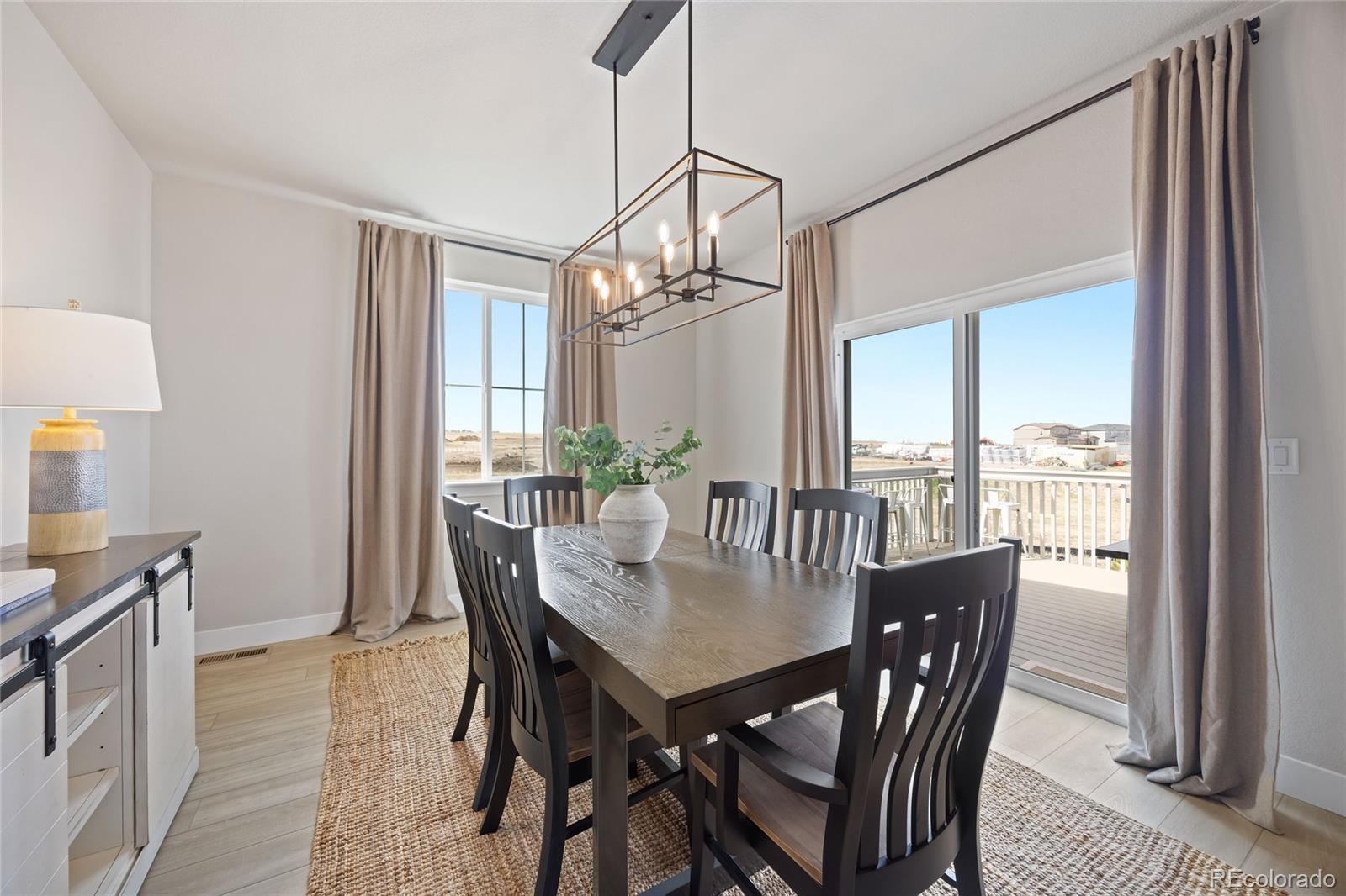 12649 Buffington Trail Parker, CO 80134 - Photo 15 of 47 a view of a dining room with furniture window and wooden floor