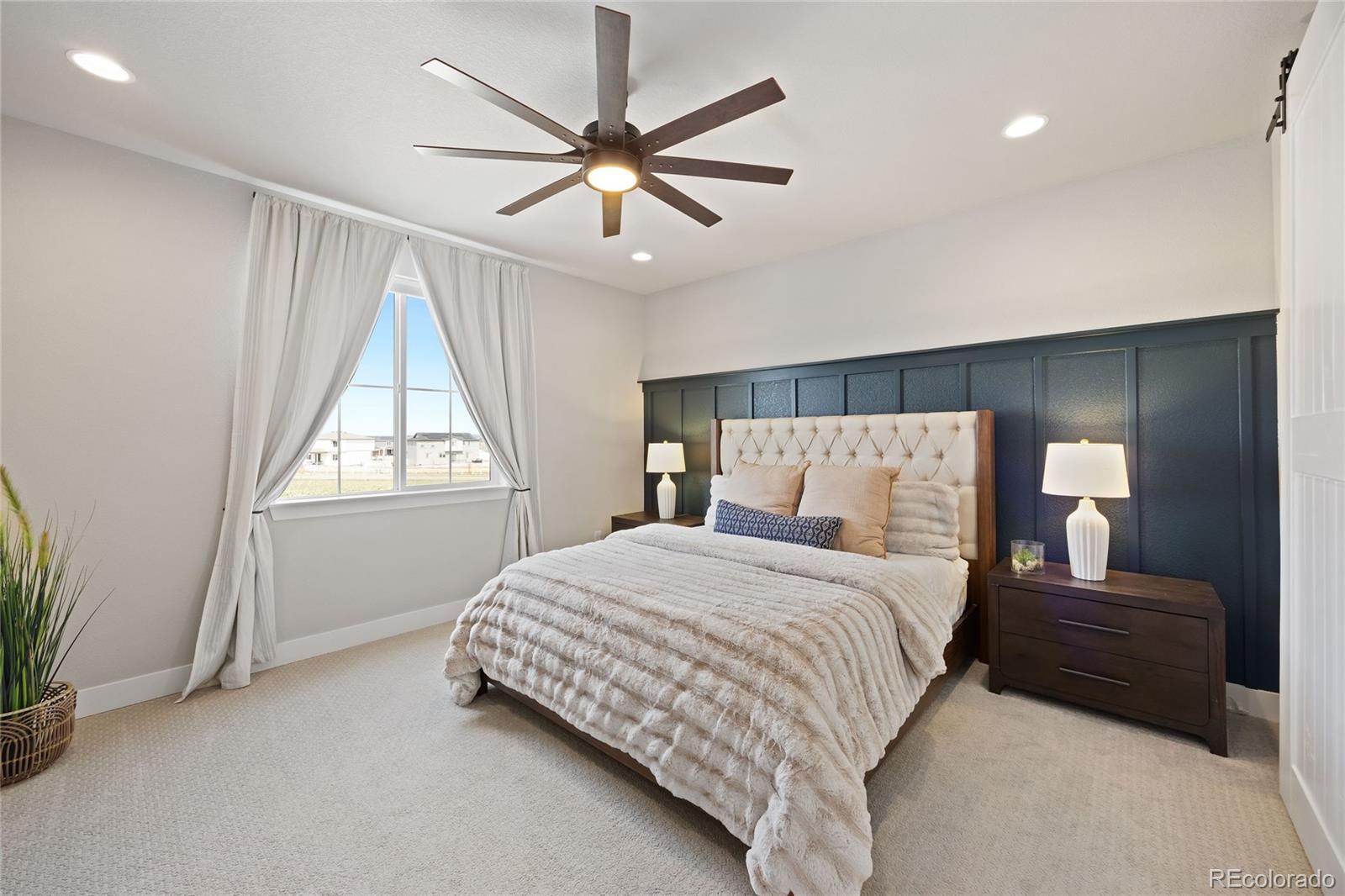 12649 Buffington Trail Parker, CO 80134 - Photo 18 of 47 a bedroom with a large bed and a window