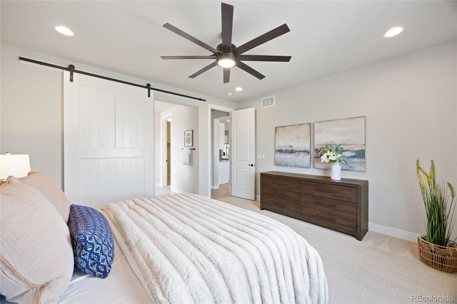 12649 Buffington Trail Parker, CO 80134 - Photo 19 of 47 a bedroom with a bed chandelier and a closet