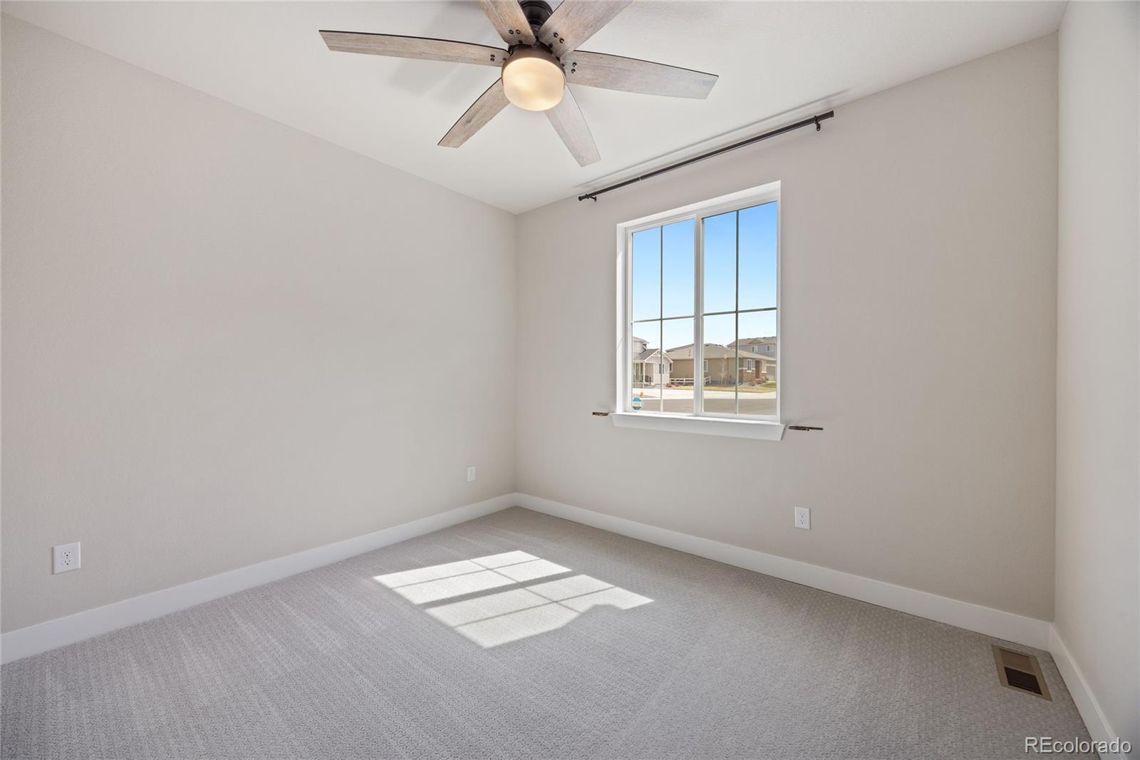 12649 Buffington Trail Parker, CO 80134 - Photo 24 of 47 an empty room with a window and ceiling fan