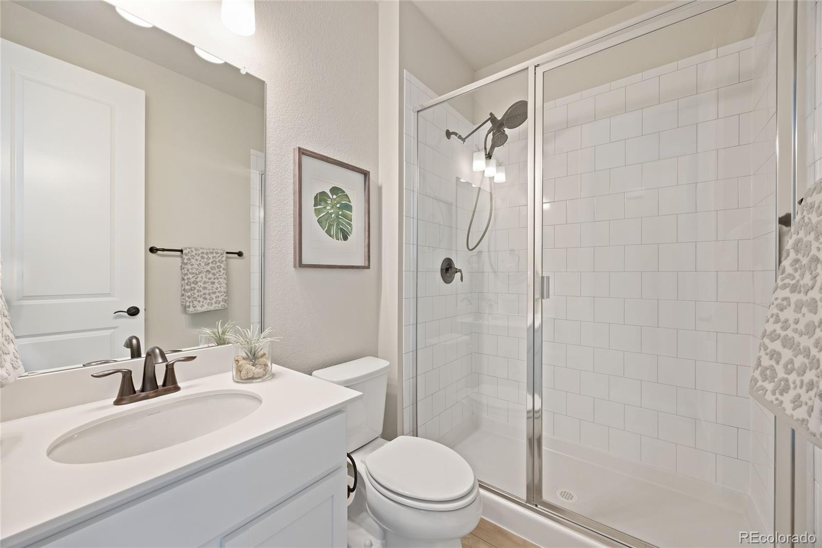 12649 Buffington Trail Parker, CO 80134 - Photo 26 of 47 a bathroom with a sink toilet vanity and shower