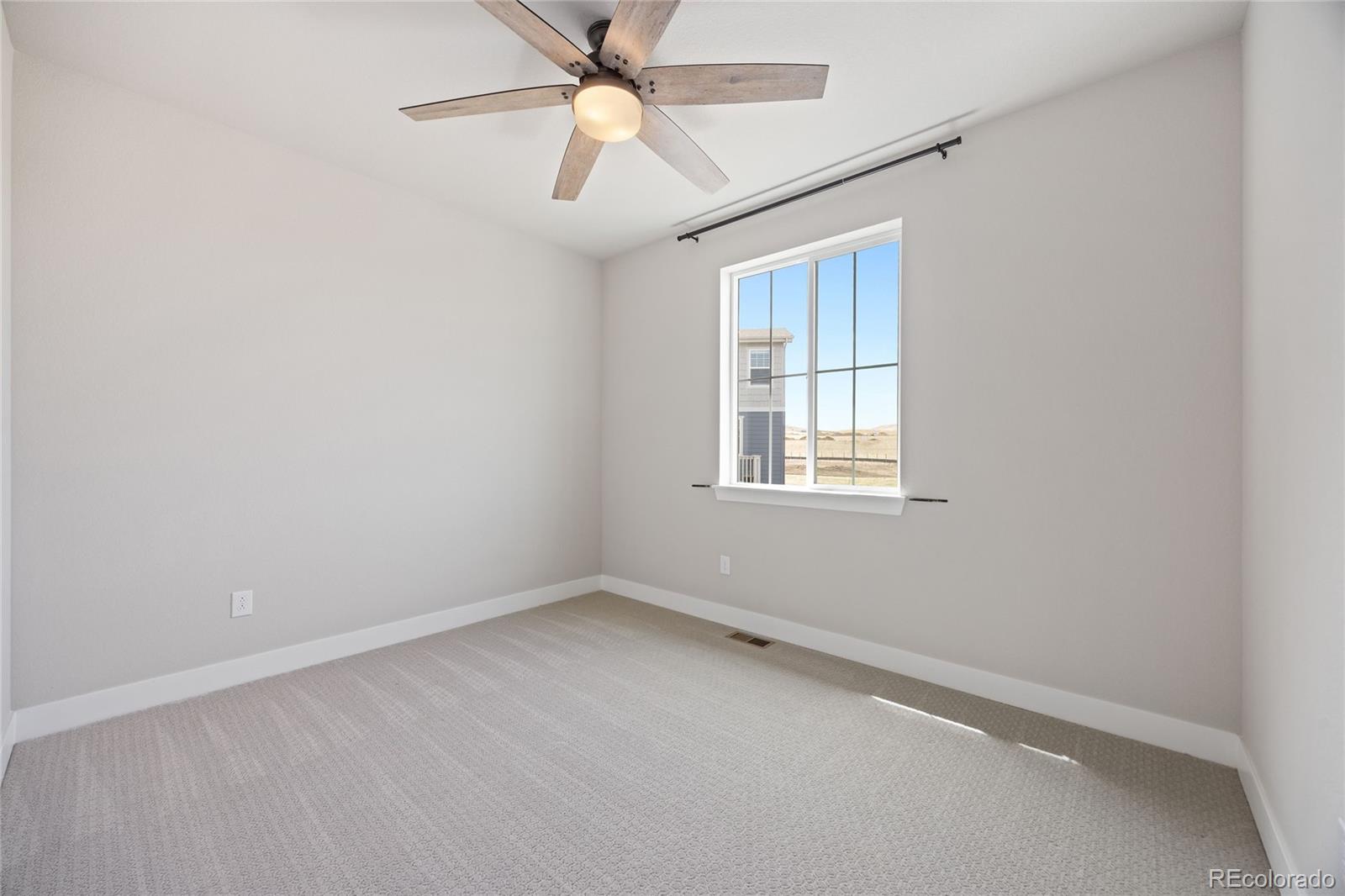 12649 Buffington Trail Parker, CO 80134 - Photo 27 of 47 an empty room with a window and a fan